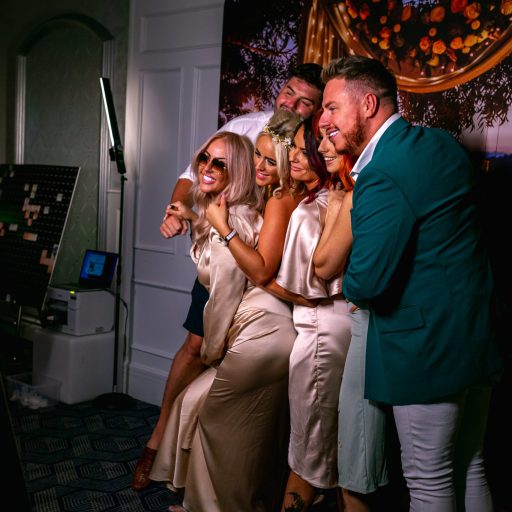 A group of guests posing for photos on the Mirror me