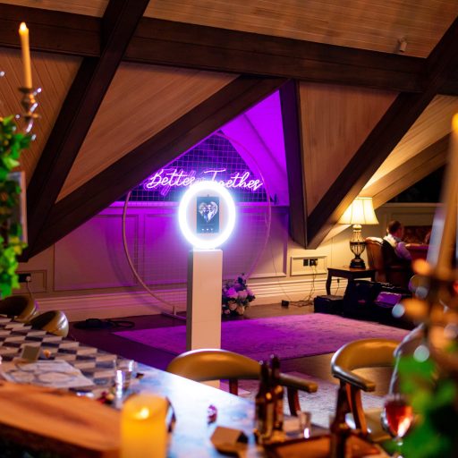 The Mobi Aura sitting waiting in a beautiful wedding venue, in front of a neon Better Together sign, for guests to get their photos taken